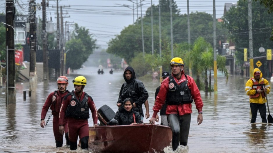 Firefighters rescue locals in a boat, at Santos Dumont neighbourhood in Sao Leopoldo, Rio Grande do Sul, Brazil, on May 12, 2024