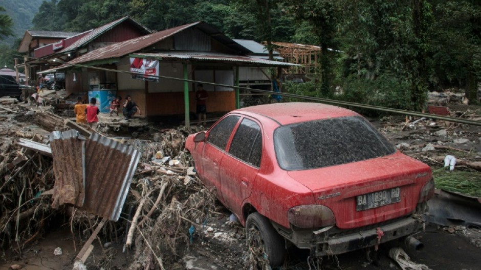 Flash floods and cold lava flow from a volcano hit several districts in western Indonesia