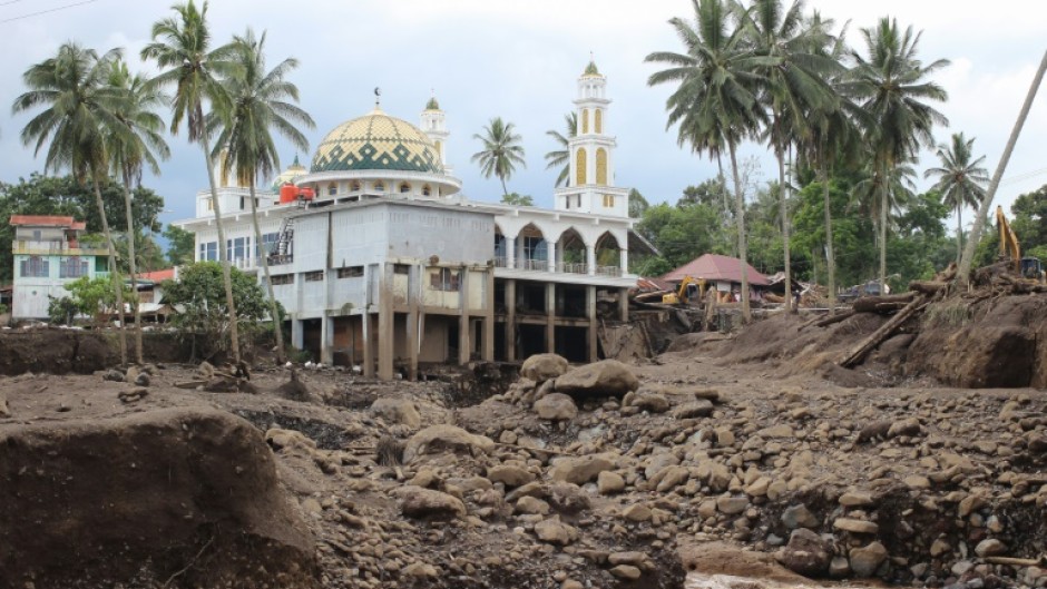 Hours of heavy rain caused large volcanic rocks to roll down one of Indonesia's most active volcanos into two of the worst-hit districts on Sumatra island