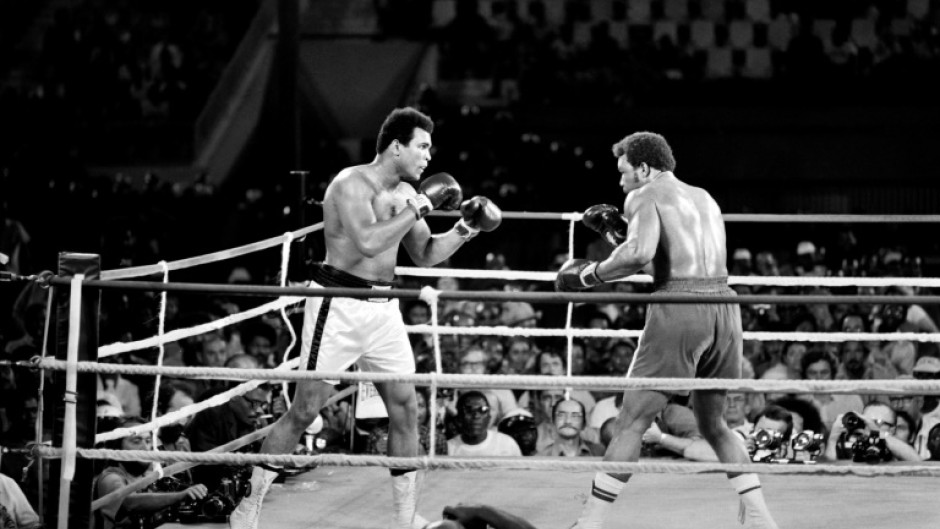 Muhammad Ali (L) reclaiming his world titles from George Foreman in Kinshasa, Zaire, in 1974