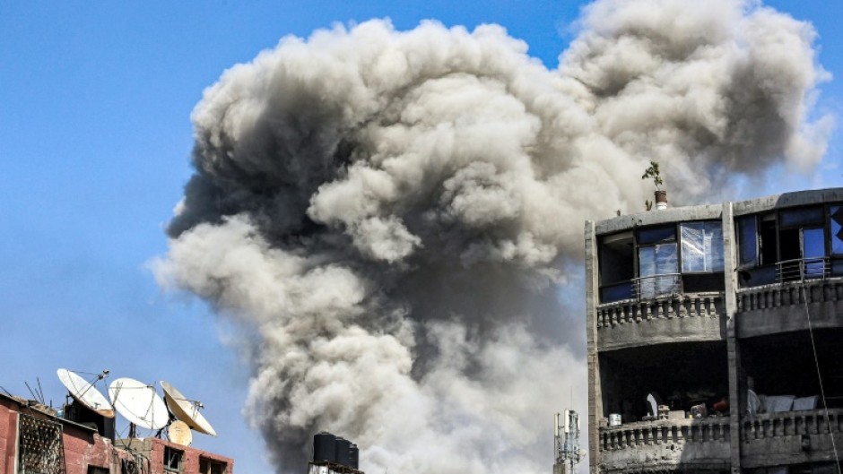 A smoke plume rises during Israeli bombardment in Jabalia in the northern Gaza Strip on May 14, 2024 