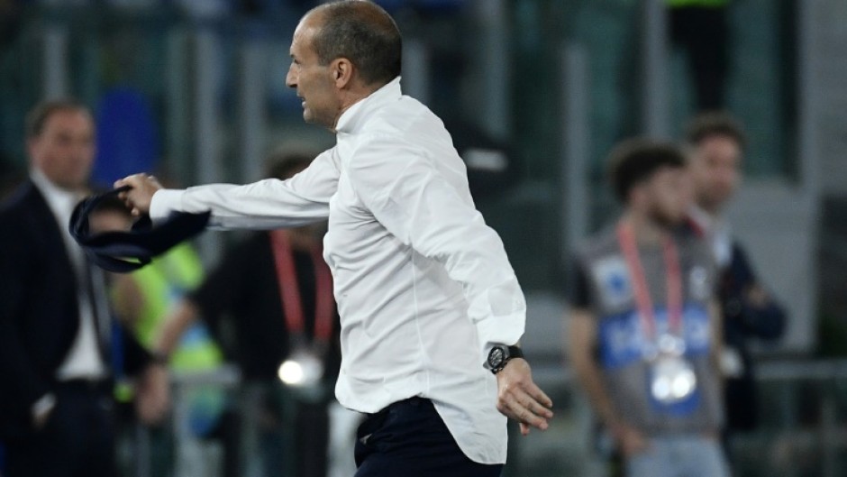 Juventus coach Massimiliano Allegri tosses away his tie after seeing red during his side's 1-0 victory against Atalanta in the Italian Cup final