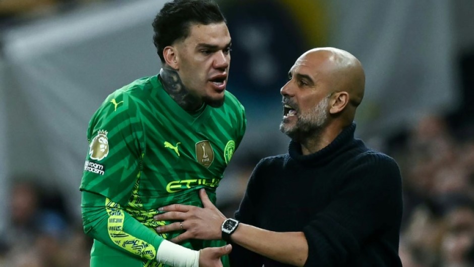 Reluctant to come off: Manchester City goalkeeper Ederson (L) argues with manager Pep Guardiola while being substituted during a 2-0 win over Tottenham Hotspur