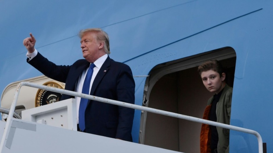 Former US president Donald Trump, pictured with son Barron in 2020, complained that he would be unable to attend the graduation ceremony -- but ultimately was granted a trial recess