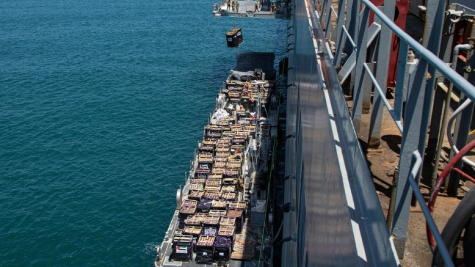 US CENTCTOM picture shows Gaza-bound aid lifted by crane at the Ashdod port in southern Israel