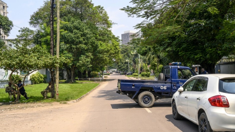 The Congolese Republican Guard and police block a road around the scene after the army said it had thwarted an attempted coup in the capital Kinshasa