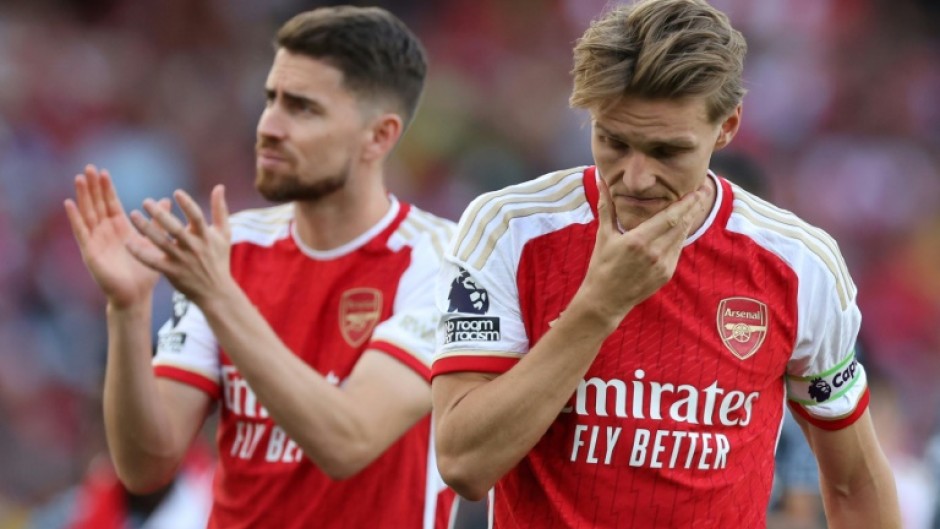 Arsenal's Martin Odegaard (R) and Jorginho (L) react after their title disappointment