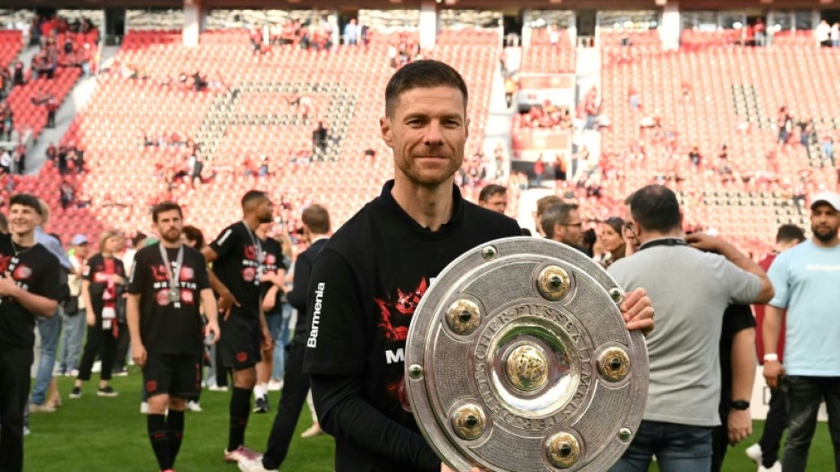 'Outstanding': Bayer Leverkusen coach Xabi Alonso poses with the Bundesliga trophy 