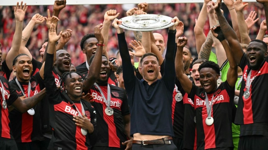 Champions: Bayer Leverkusen coach Xabi Alonso and his players celebrate with the Bundesliga trophy