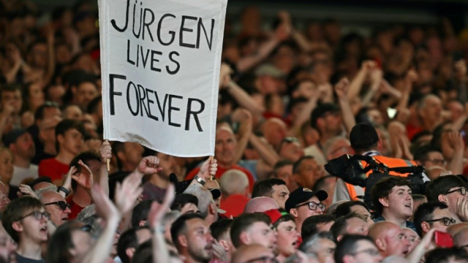 Liverpool fans hold a banner reading "Jurgen Lives Forever" 