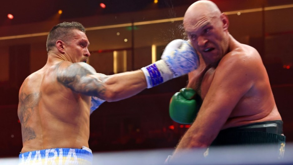 Ukraine's Oleksandr Usyk (L) on the way to a split decision victory over Britain's Tyson Fury for the undisputed heavyweight world title