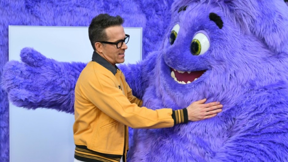 Actor and producer Ryan Reynolds hugs Blue as he arrives for the premiere of 'If' at the SVA Theater on May 13, 2024 in New York City