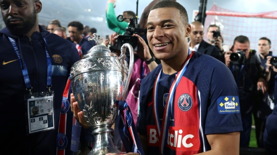 Kylian Mbappe parades the trophy after PSG beat Lyon 2-1 in Saturday's French Cup final 