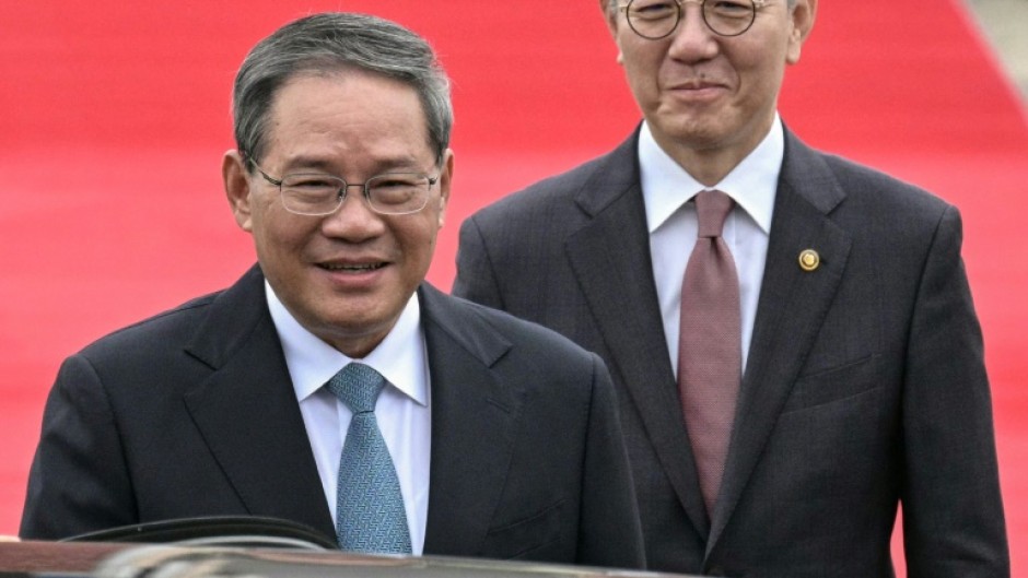 Chinese Premier Li Qiang (L, with South Korea's Vice Foreign Minister Kim Hong-kyun) arrives in Seoul for the summit with Japan and South Korea