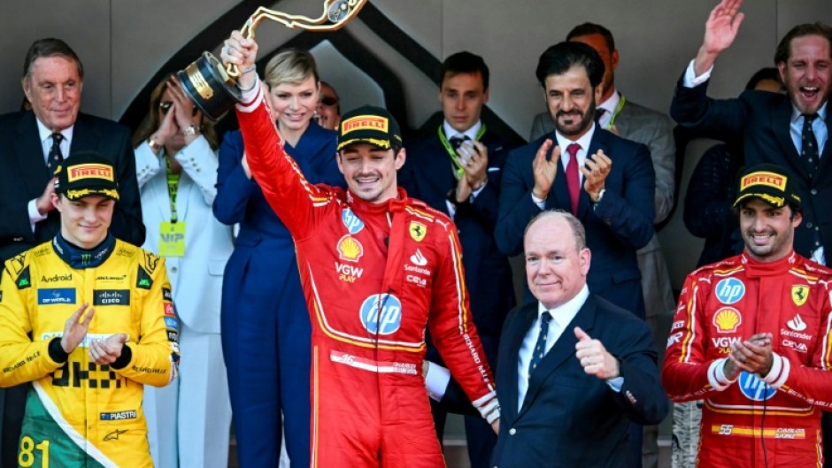 Charles Leclerc celebrates his first home Monaco Grand Prix alongside his Principality's head of state, Prince Albert II