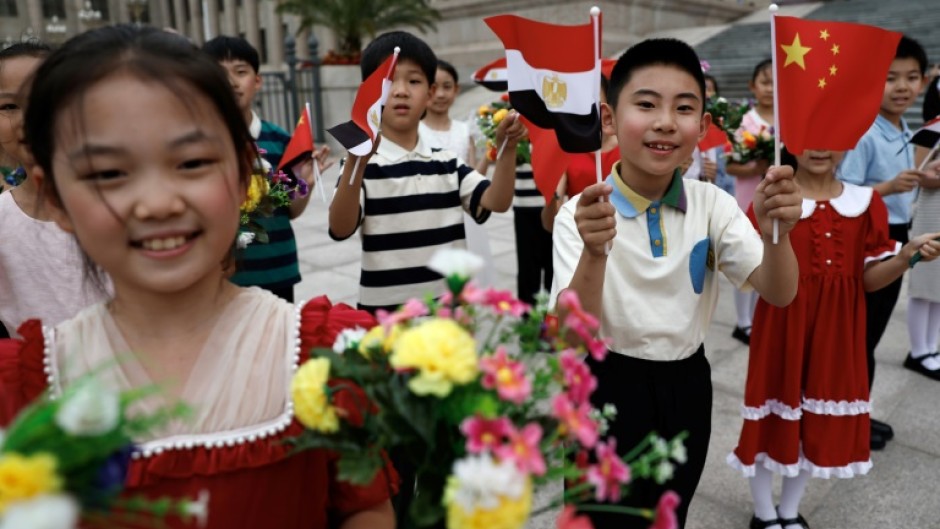 Children cheer as they rehearse for a welcome ceremony for Egyptian President Abdel Fattah al-Sisi at the Great Hall of the People in Beijing