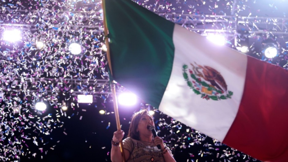 Opposition presidential candidate Xochitl Galvez waves the Mexican flag during a campaign rally