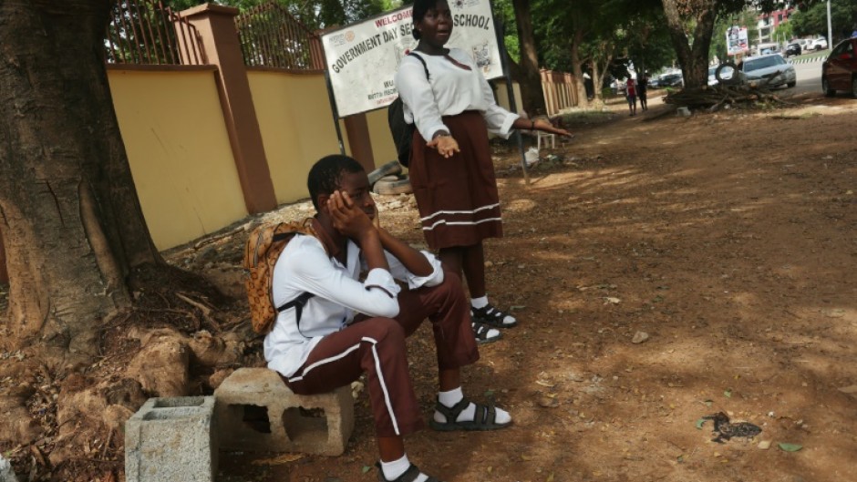 Students wait outside their Government Science Secondary School in the capital after unions launched an indefinite strike for a higher minimum wage