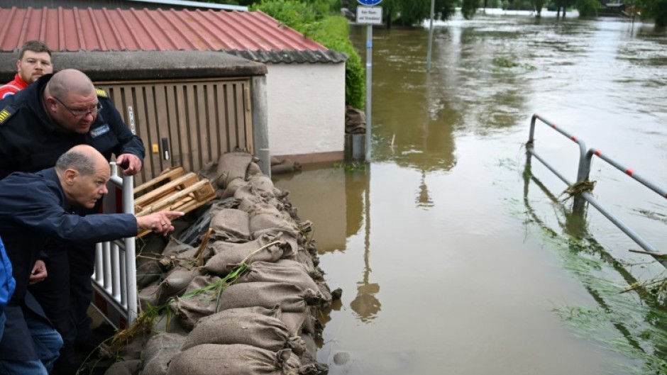 German Chancellor Olaf Scholz drew links to climate change as he visited flood-hit areas in southern Germany