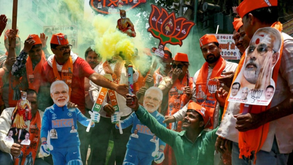 Supporters of Prime Minister Narendra Modi carry his cut out as they celebrate in Varanasi on June 4