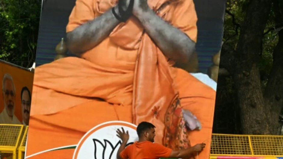 A supporter of India's Prime Minister Narendra Modi carries his portrait on Tuesday as results were announced in the general elections 