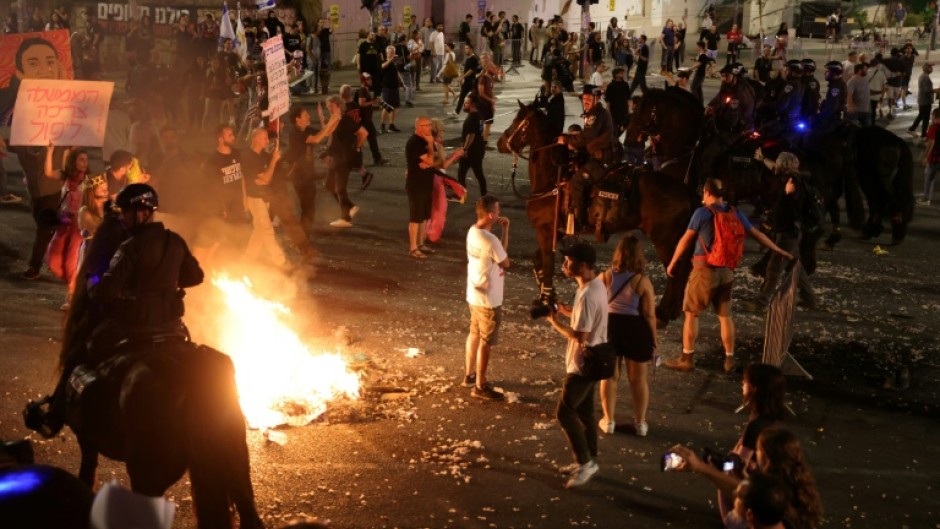 Mounted Israeli police try to disperse a demonstration by relatives and supporters of Israelis held hostage by Palestinian Hamas militants in Gaza since the October 7 attacks, in Tel Aviv early on June 2, 2024