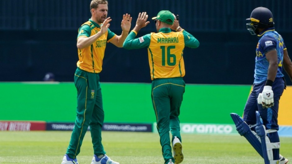 South Africa's Anrich Nortje (L) celebrates after dismissing Sri Lanka's Kamindu Mendis (R) as the paceman took 4-7 in South Africa's 6-wicket win over Sri Lanka at the T20 World Cup