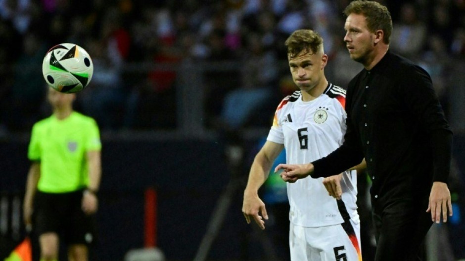 Germany's head coach Julian Nagelsmann (r), flanked by  veteran defender Joshua Kimmich, gives directions against Ukraine 