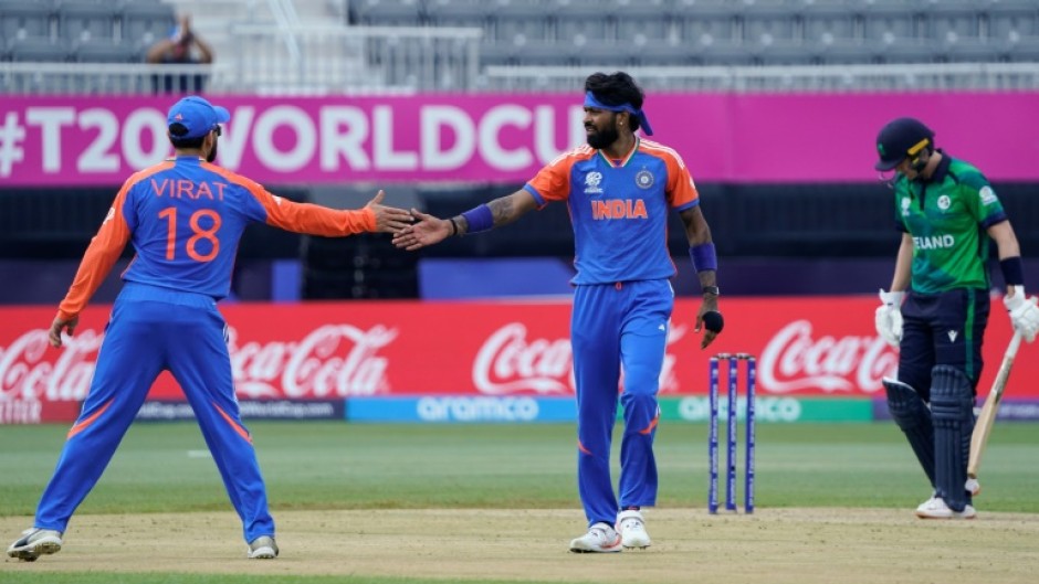 India's Hardik Pandya (C) celebrates with Virat Kohli (L) after taking a wicket in a T20 World Cup match against Ireland in New York