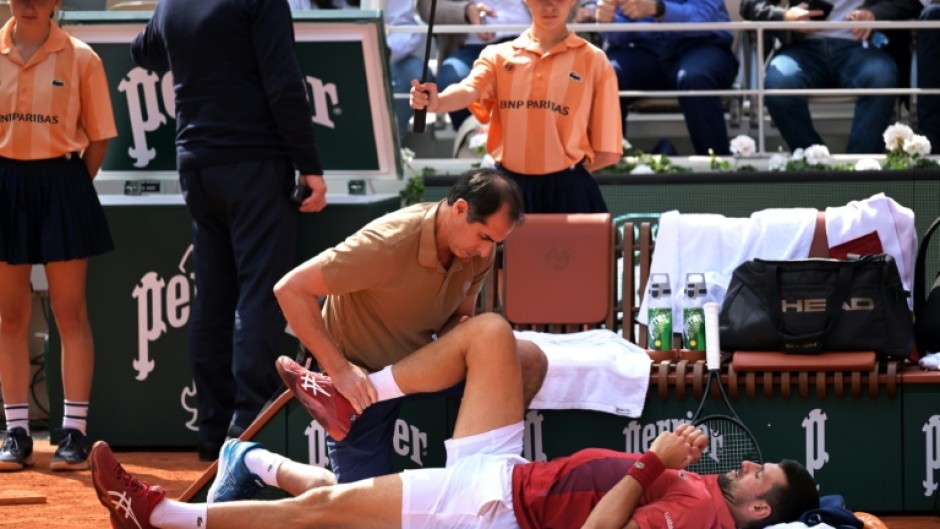 Novak Djokovic received treatment during his victory against Francisco Cerundolo at the French Open after which he withdrew with a knee injury