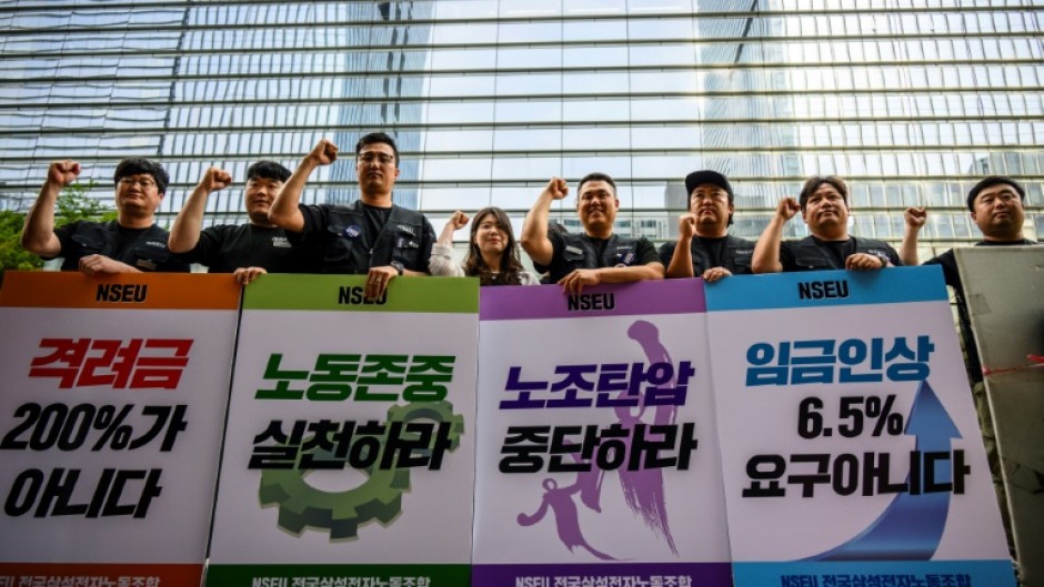 Samsung Electronics' union members hold placards during a rally outside the company building in Seoul 