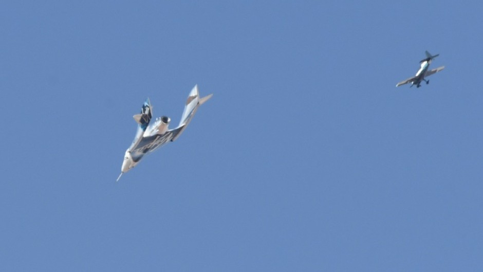 The Virgin Galactic SpaceShipTwo spaceplane Unity and mothership separate as they fly way above Spaceport America in New Mexico in July 2021 on the way to the cosmos