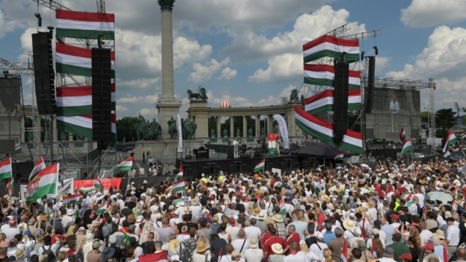 Posters held by the cheering masses read 'Wake up Hungarians' and 'We are masters of our future'