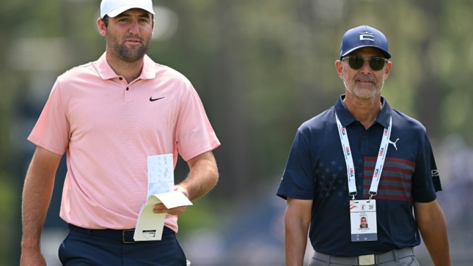 World number one Scottie Scheffler, left, walks with golf instructor Claude Harmon III on the fourth hole during a practice round ahead of Thursday's start of the 124th US Open at Pinehurst