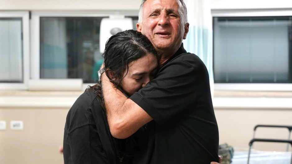 Freed Israeli hostage Noa Argamani, 26, is embraced by her father at a hospital on June 8, 2024