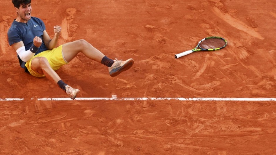 Carlos Alcaraz celebrates after winning his first French Open title