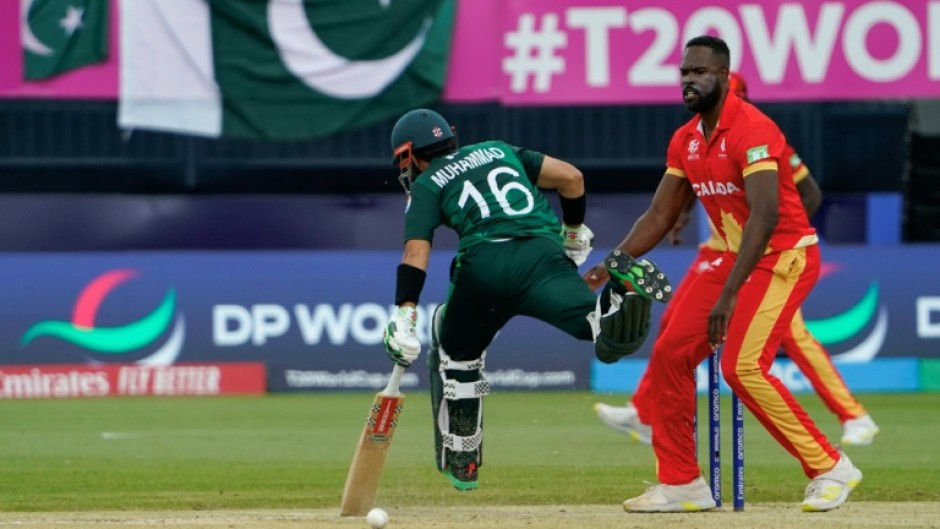 On the run: Pakistan's Mohammad Rizwan makes his ground as Canada's Jeremy Gordon looks on 