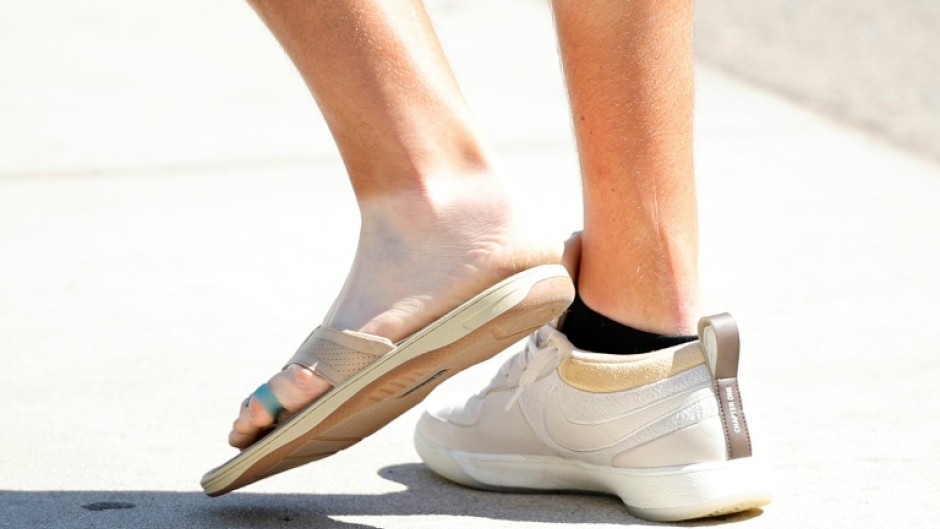 Two-time major winner Jon Rahm of Spain shows off the flip-flop he wore Tuesday at Pinehurst because of a left foot infection that has him questionable for playing in this week's 124th US Open