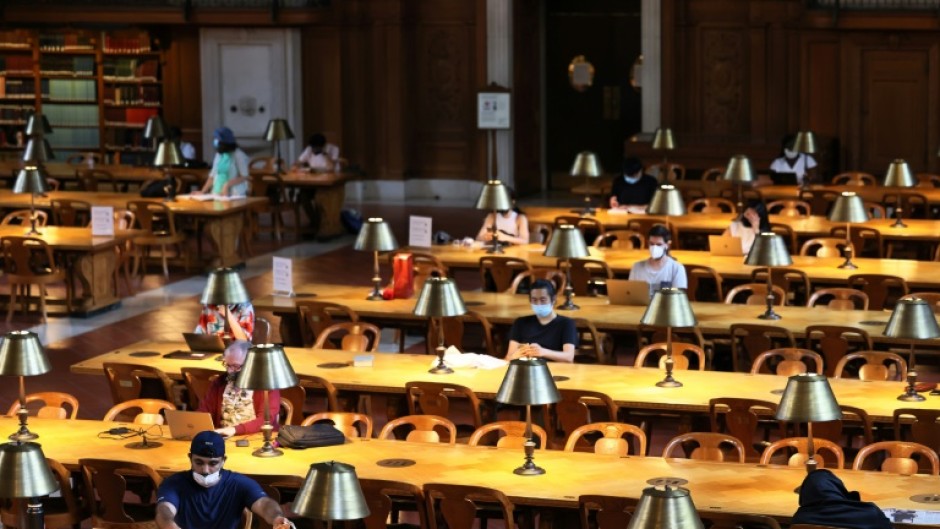 People read their computers in the New York Public Library in July 2021 in Manhattan 