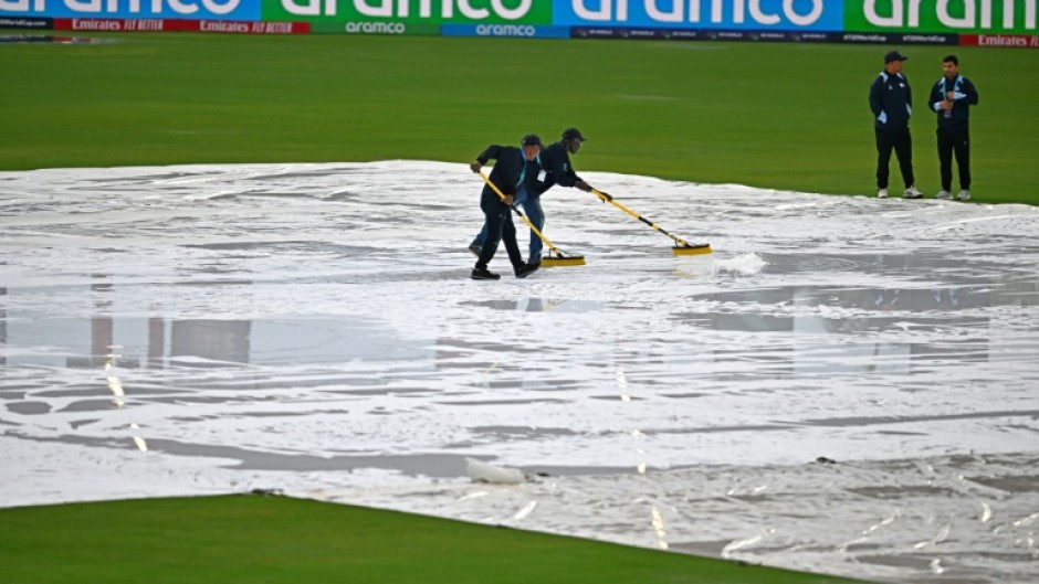 Match officials wipe water from the pitch but the ICC men's Twenty20 World Cup 2024 group D cricket match between Sri Lanka and Nepal at Central Broward Park was ultimately called off