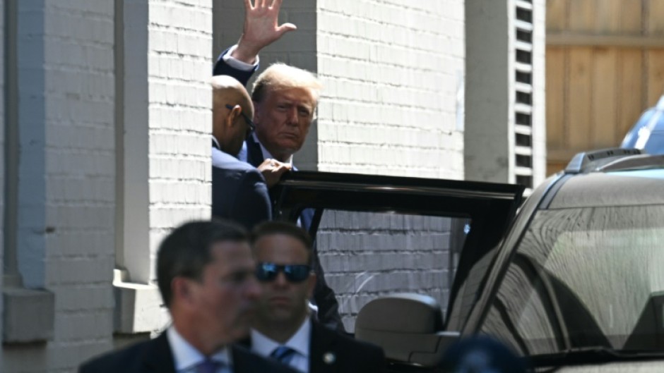 Former US president Donald Trump waves as he departs the Capitol Hill Club following a meeting with US House Republicans on Capitol Hill in Washington, DC, on June 13, 2024