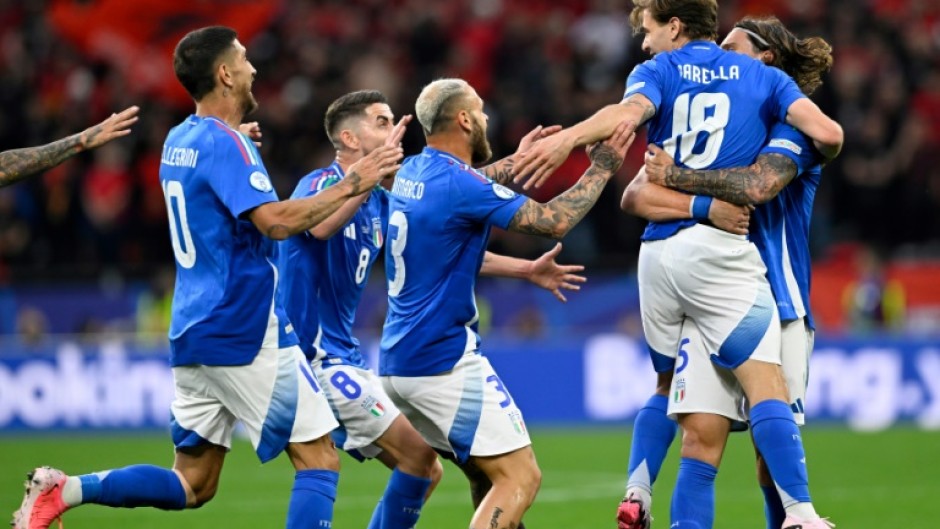 Italy players celebrate with Nicolo Barella after he scored what proved to be his side's winner against Albania