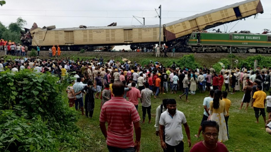 Three passenger carriages were derailed and flipped on their side, while another carriage was thrust high into the air precariously balanced on another