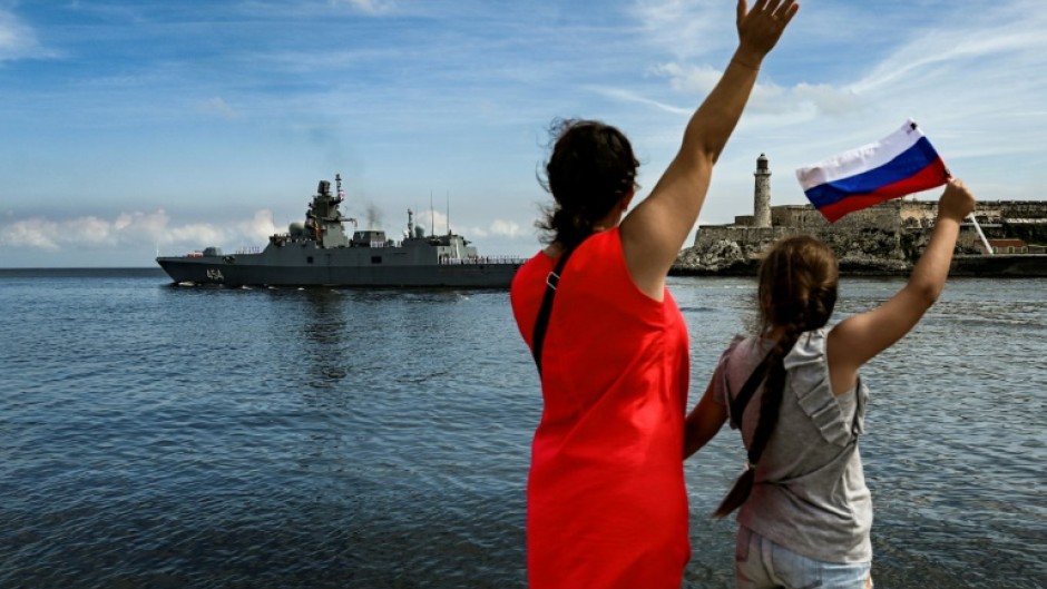 Cubans wave as Russian ships leave the Havana harbor after a five-day visit