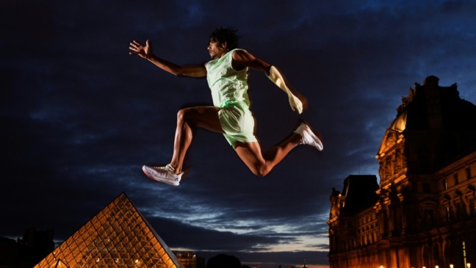 Paralympic jumper Arnaud Assoumani in front of the Pyramid at the Louvre