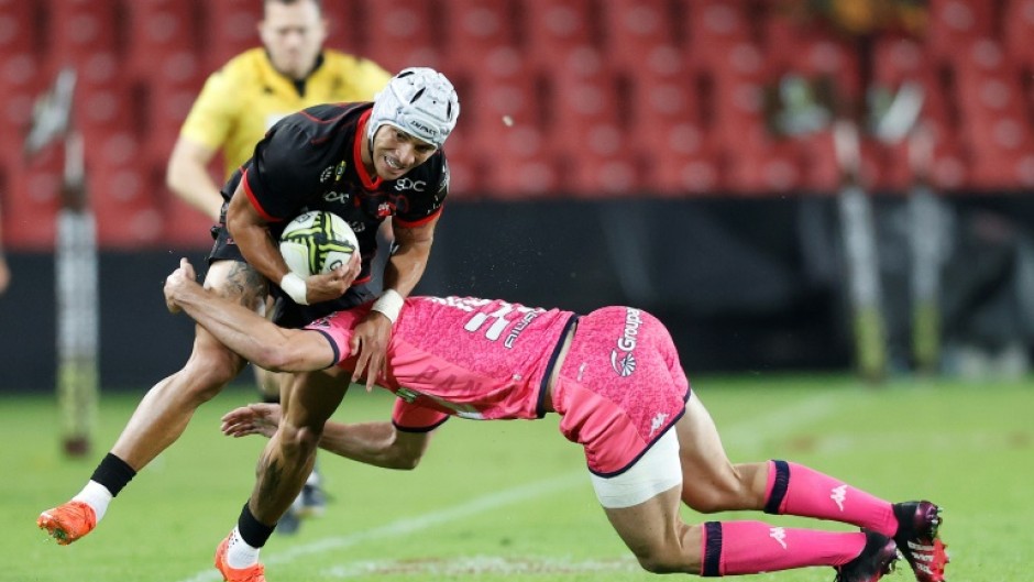 Lions wing Edwill van der Merwe (L) is tackled during a European Challenge Cup against Stade Francais in Johannesburg.
