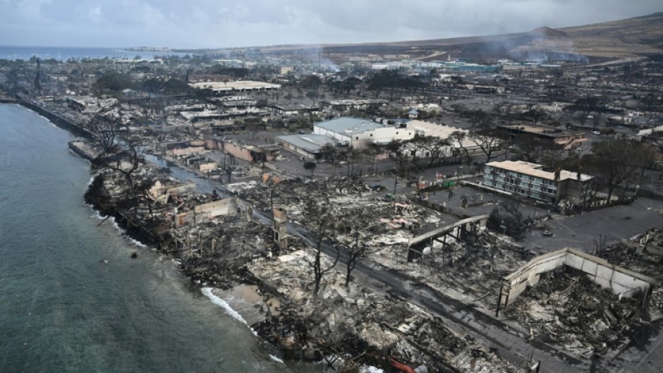 An aerial image shows Old Lahaina Center and Foodland Lahaina standing amongst destroyed homes and businesses along Front Street burned to the ground in the historic Lahaina in the aftermath of wildfires in western Maui in Lahaina, Hawaii 