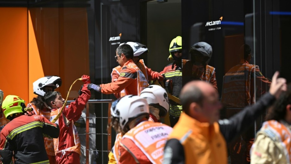 Firefighters at an incident at McLaren's hospitality unit before third practice