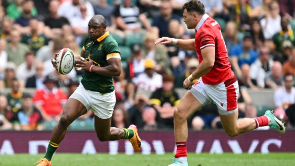 On the attack: South Africa wing Makazole Mapimpi takes on Wales centre Mason Grady at Twickenham 