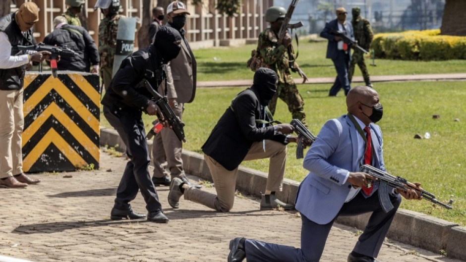 Kenya Police officers and security personnel take positions at the Kenyan Parliament